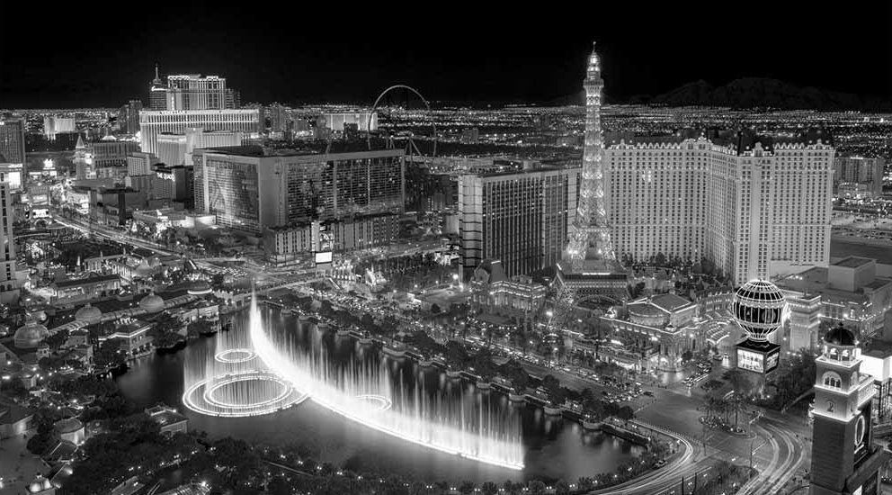 Black and white photo of Las Vegas Strip with Bellagio fountains and Eiffel Tower