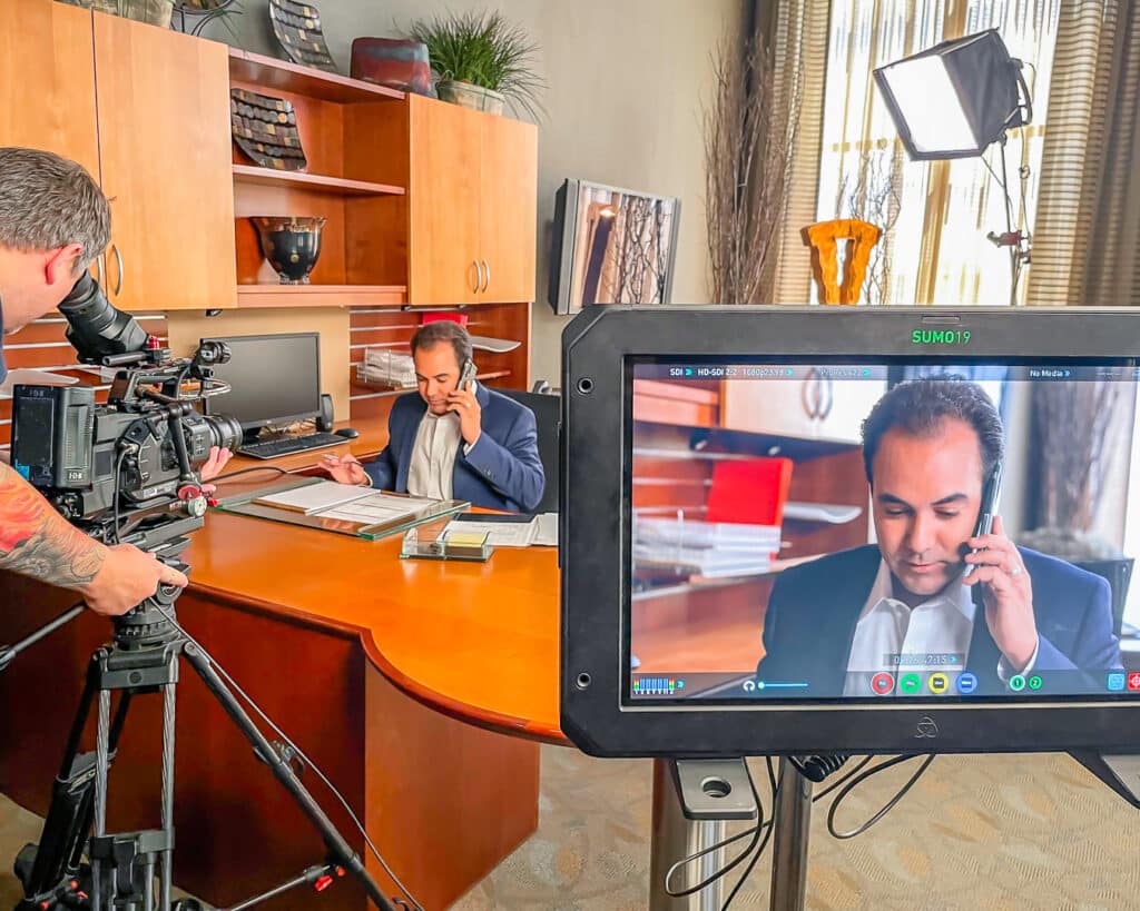 Las Vegas video production company filming marketing material in office with man on phone 
