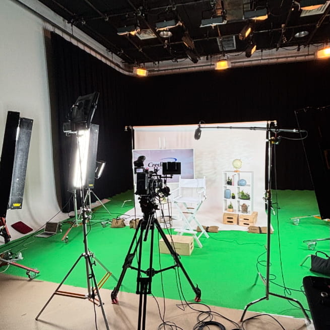 Modern studio setup with green screen, cameras, and professional lighting, highlighting current trends in corporate video production.